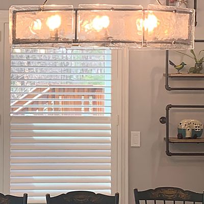 White wood shutters by Hunter Douglas in the dining area