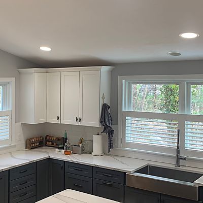 Mansfield, MA home renovation included Hunter Douglas white wood shutters throughout the renovated first floor