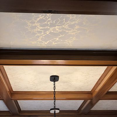 The beautiful traditional wood paneling and coffered ceiling in the dining room are balanced by adding color and contrast.