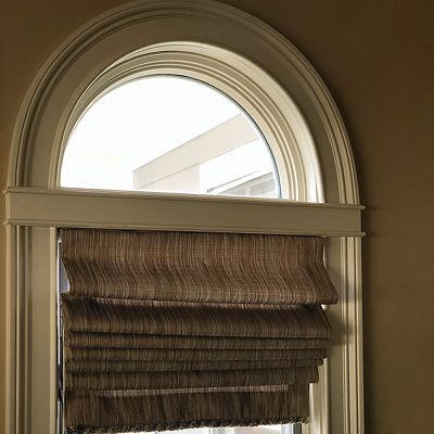 Roman shades offer flexibility with light control and privacy options.
