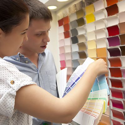 Couple selecting paint color in a store